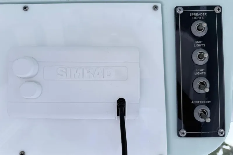 Slide: The Image of Control panel of 2024 Sea Pro 222 Center Console with Simrad system and light switches. - 8