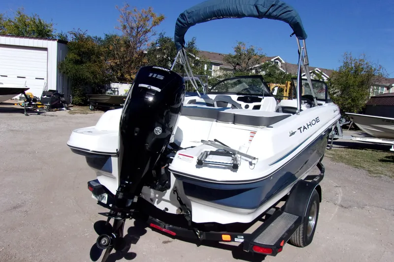 Slide: The Image of 2021 Tahoe 550 TF boat with Mercury 115 engine on trailer in outdoor setting. - 3