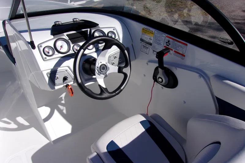 Slide: The Image of 2021 Tahoe 550 TF boat cockpit with steering wheel and control panel. - 5
