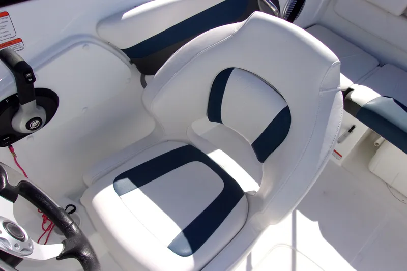 Slide: The Image of Captain's seat in 2021 Tahoe 550 TF boat, featuring white and blue upholstery. - 7