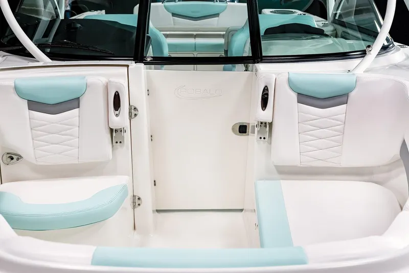 Slide: The Image of 2026 Robalo R317 Dual Console boat with twin 350 V6 engines displayed indoors. - 6