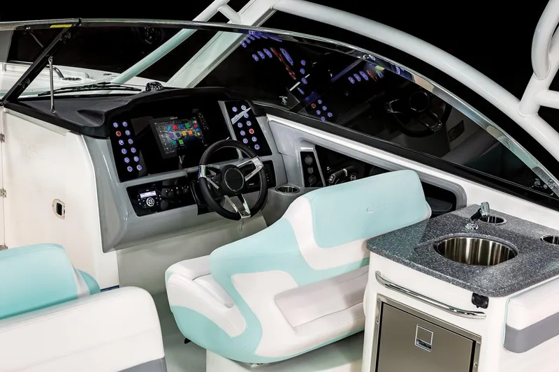 Slide: The Image of 2026 Robalo R317 Dual Console boat interior with blue LED lighting and seating arrangement. - 7