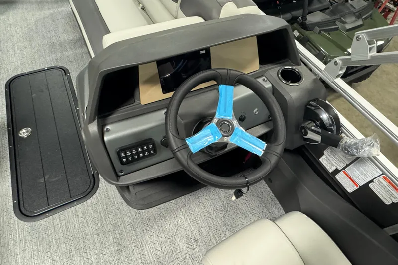 Slide: The Image of 2026 Sun Tracker SportFish 22 XP3 boat dashboard with steering wheel and control panel. - 15