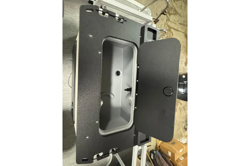 Slide: The Image of Open storage compartment on 2026 Sun Tracker SportFish 22 XP3 boat. - 21