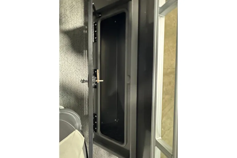 Slide: The Image of Open storage compartment on 2026 Sun Tracker SportFish 22 XP3 boat. - 24