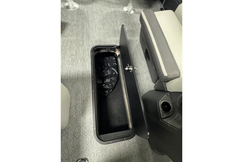 Slide: The Image of 2026 Sun Tracker SportFish 22 XP3 storage compartment with open lid, revealing interior space. - 25