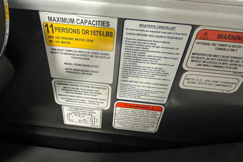 Slide: The Image of Capacity and safety labels on 2026 Sun Tracker SportFish 22 XP3 boat. - 17