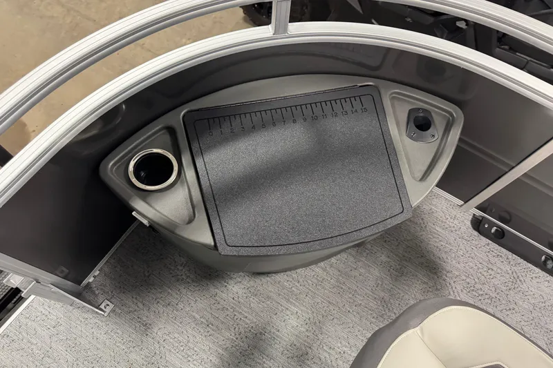 Slide: The Image of 2026 Sun Tracker SportFish 22 XP3 boat console with cup holder and measuring board. - 8