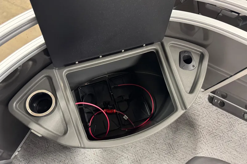 Slide: The Image of 2026 Sun Tracker SportFish 22 XP3 storage compartment with cup holder and wiring. - 9