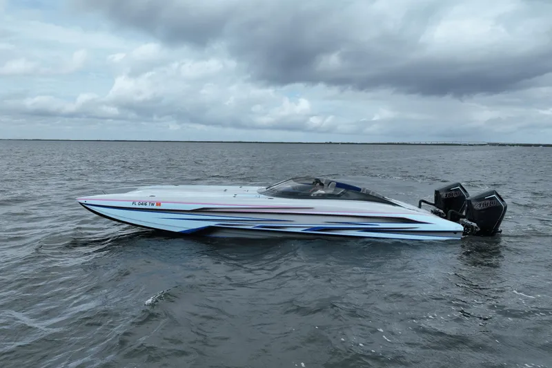 The Image of 2024 Dug Wright 32 speedboat on open water under cloudy skies. - 0