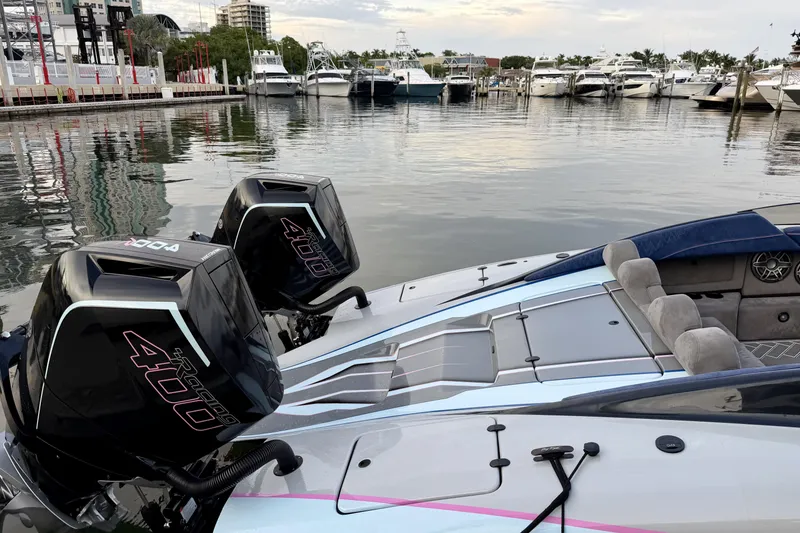 Slide: The Image of 2024 Dug Wright 32 boat with twin 400 engines docked at marina. - 10