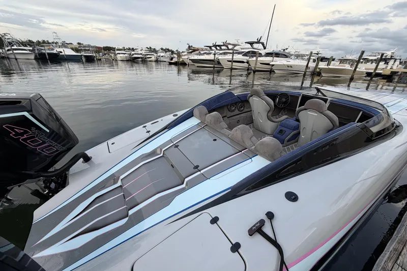 Slide: The Image of 2024 Dug Wright 32 speedboat docked, featuring sleek design and powerful engine. - 13