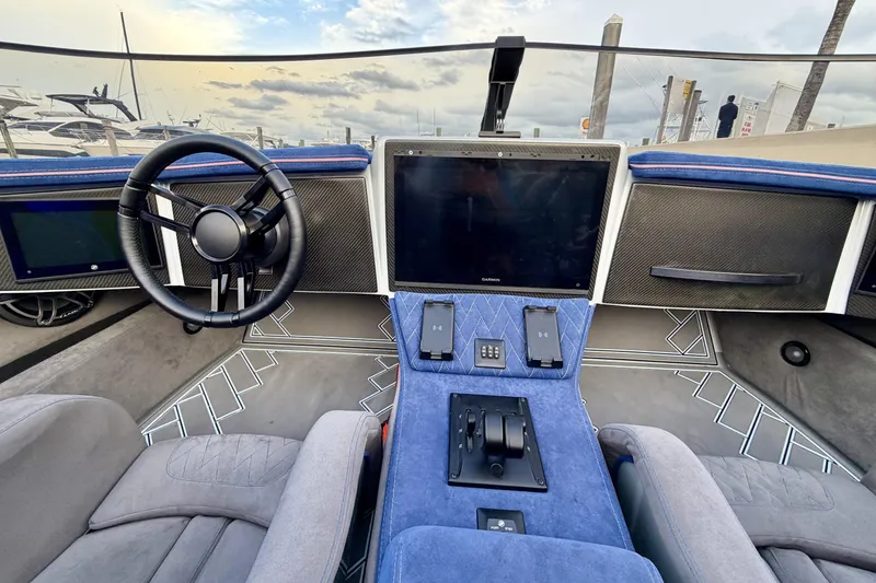 Slide: The Image of 2024 Dug Wright 32 boat interior with modern steering and navigation system. - 18