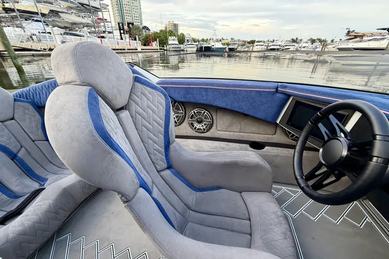 Slide: The Image of Luxurious interior of 2024 Dug Wright 32 boat with plush seating and modern dashboard. - 21