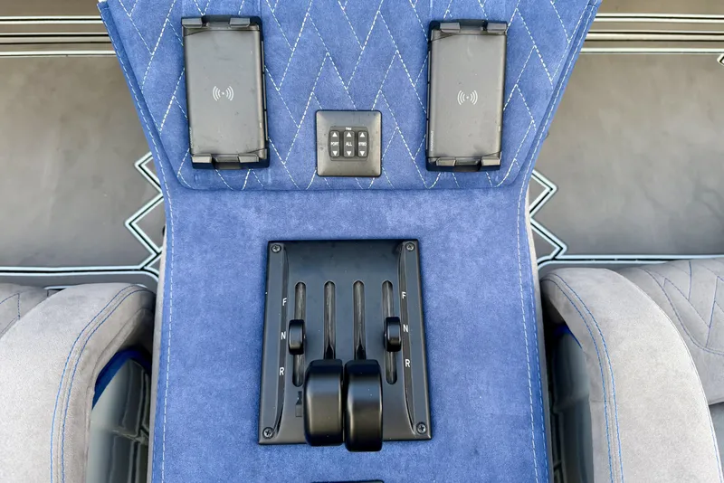 Slide: The Image of Blue interior of 2024 Dug Wright 32 with control panel and wireless chargers. - 22