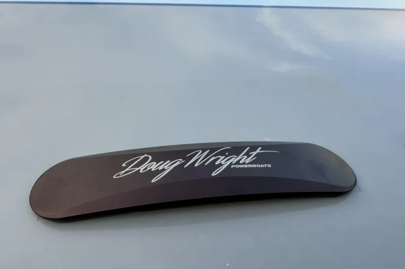 Slide: The Image of Doug Wright Powerboats logo on a sleek surface, 2024 model. - 27