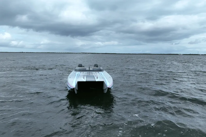 Slide: The Image of 2024 Dug Wright 32 boat on open water under cloudy sky. - 3