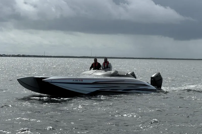 Slide: The Image of 2024 Dug Wright 32 powerboat on water under cloudy sky. - 8