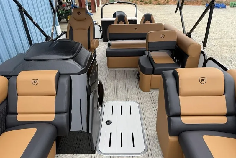 Slide: The Image of Luxurious interior of 2026 Premier 230 Sunsation RS CL pontoon boat with tan and black seating. - 12