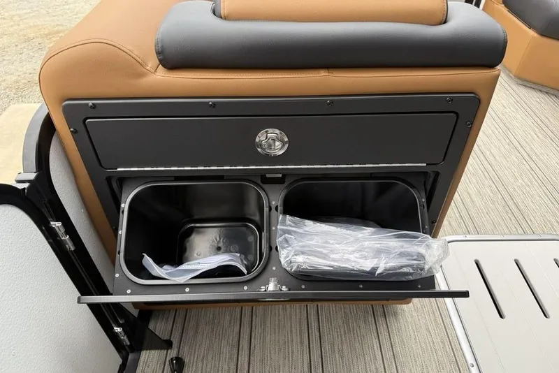 Slide: The Image of 2026 Premier 230 Sunsation RS CL boat storage compartment with dual bins and sleek design. - 13