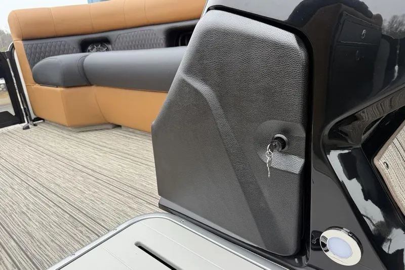 Slide: The Image of 2026 Premier 230 Sunsation RS CL interior with tan and black seating, key in ignition. - 16