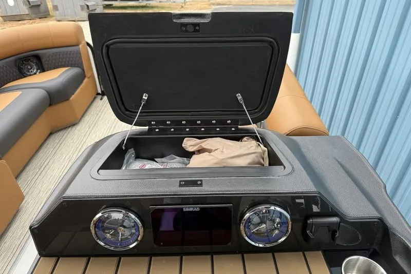 Slide: The Image of 2026 Premier 230 Sunsation RS CL dashboard with open storage compartment and modern controls. - 18