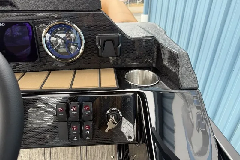 Slide: The Image of Dashboard of 2026 Premier 230 Sunsation RS CL with controls and cup holder. - 23