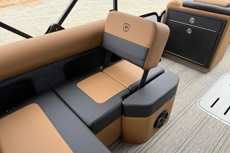Slide: The Image of Luxurious seating on 2026 Premier 230 Sunsation RS CL pontoon boat, featuring tan and gray upholstery. - 26