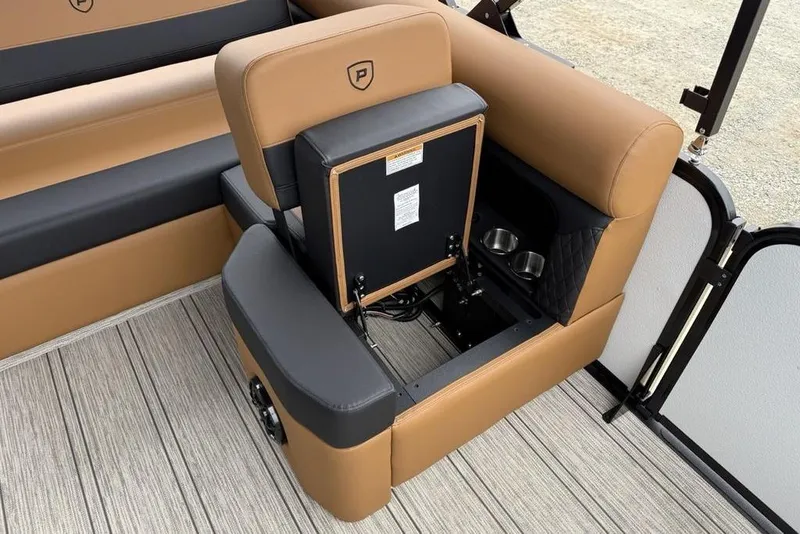 Slide: The Image of 2026 Premier 230 Sunsation RS CL boat interior with tan and black seating, cup holders, and storage. - 29