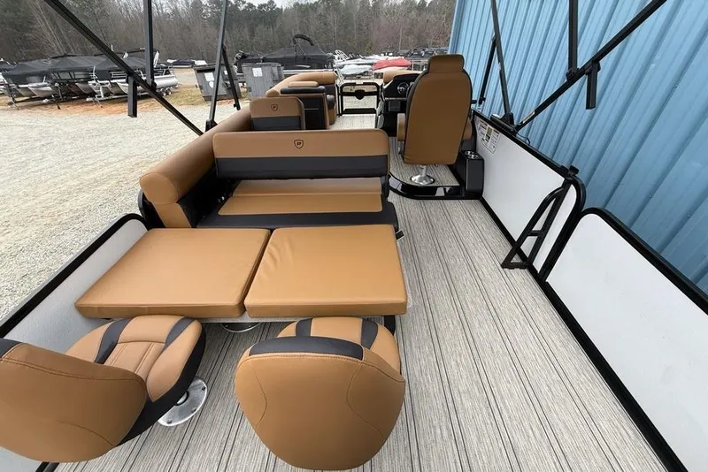 Slide: The Image of 2026 Premier 230 Sunsation RS CL pontoon boat interior with tan seating and modern design. - 38