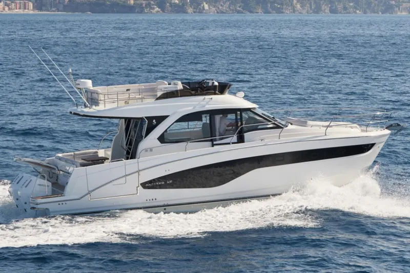 Slide: The Image of 2026 Beneteau Antares 12 Fly OB cruising on open water, side view. - 1