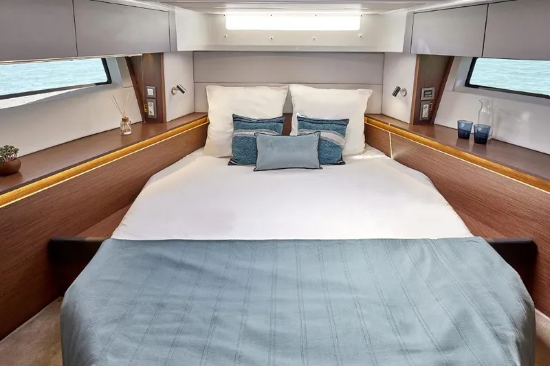 Slide: The Image of Luxurious cabin interior of 2026 Beneteau Antares 12 Fly OB with elegant bedding. - 11