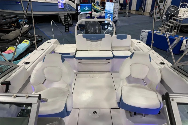 Slide: The Image of Manufacturer Provided Image: 2025 Robalo R207 Dual Console interior with white seating and storage compartments. - 20