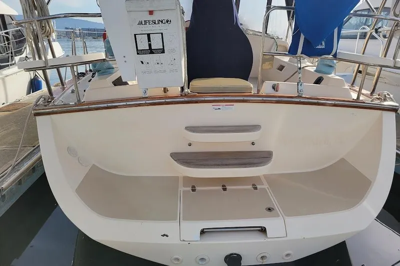 Slide: The Image of 2008 Island Packet 370 sailboat stern view with steps and lifesaving equipment. - 14