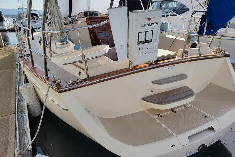 Slide: The Image of 2008 Island Packet 370 sailboat docked, showcasing spacious cockpit and safety equipment. - 15