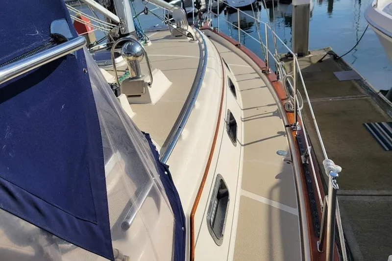 Slide: The Image of 2008 Island Packet 370 sailboat docked, showcasing deck and railing details. - 16