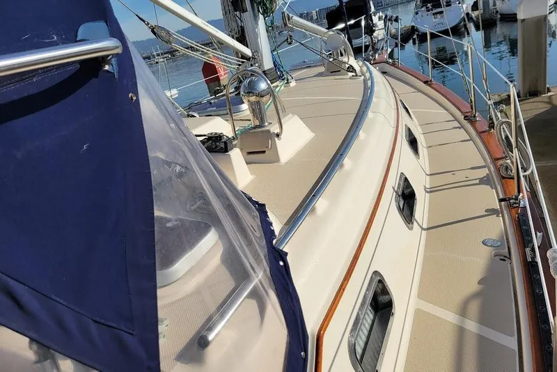 Slide: The Image of 2008 Island Packet 370 sailboat deck with blue canopy, docked in marina. - 17