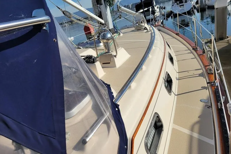 Slide: The Image of 2008 Island Packet 370 sailboat deck with blue canopy, docked in marina. - 18