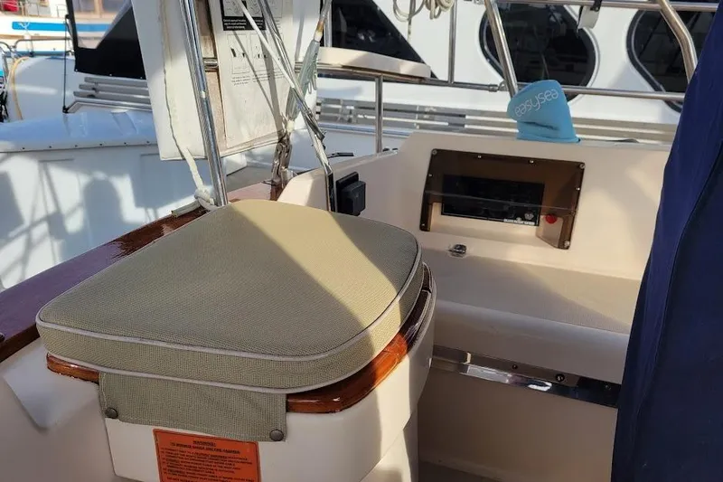 Slide: The Image of Cockpit seating area of a 2008 Island Packet 370 sailboat with beige cushion. - 26