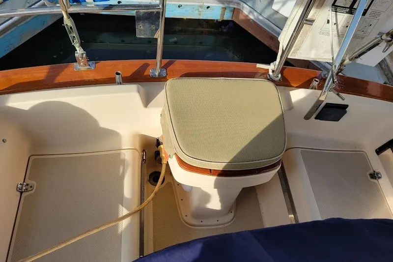 Slide: The Image of Cockpit of 2008 Island Packet 370 sailboat with cushioned seat and wooden trim. - 27