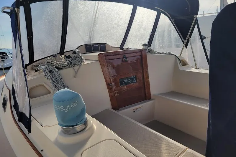 Slide: The Image of 2008 Island Packet 370 sailboat cockpit with ropes and wooden hatch. - 29