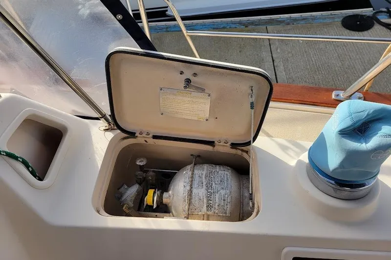 Slide: The Image of Open storage compartment on 2008 Island Packet 370 sailboat deck, revealing equipment inside. - 31