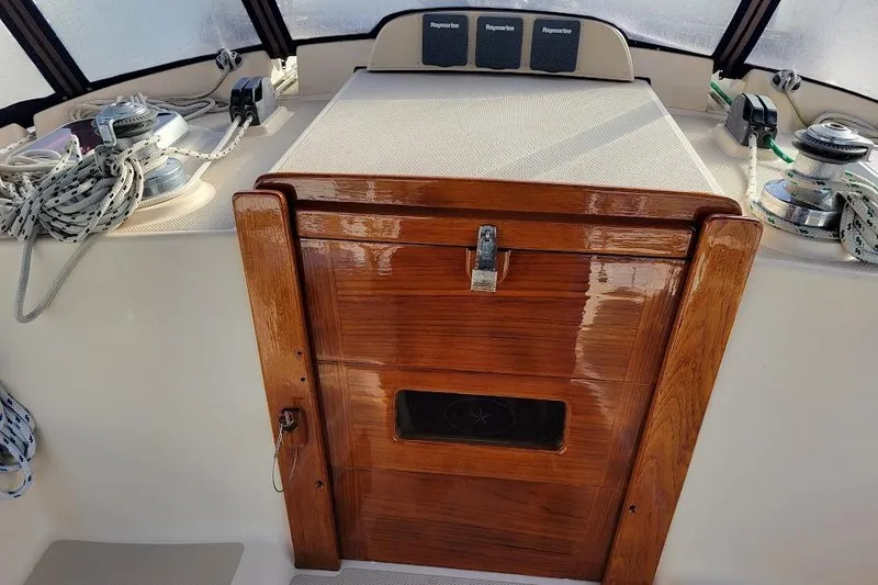 Slide: The Image of 2008 Island Packet 370 sailboat cockpit with polished wood hatch and winches. - 32