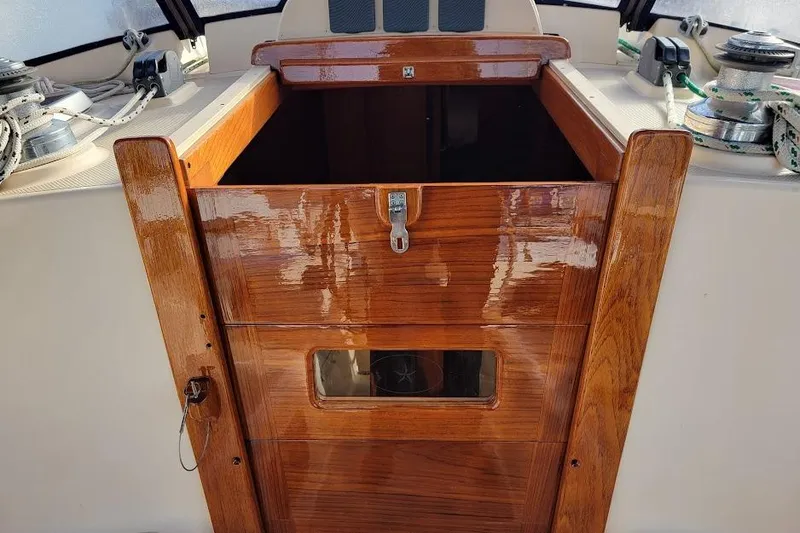 Slide: The Image of 2008 Island Packet 370 sailboat cockpit with polished wooden hatch and winches. - 33