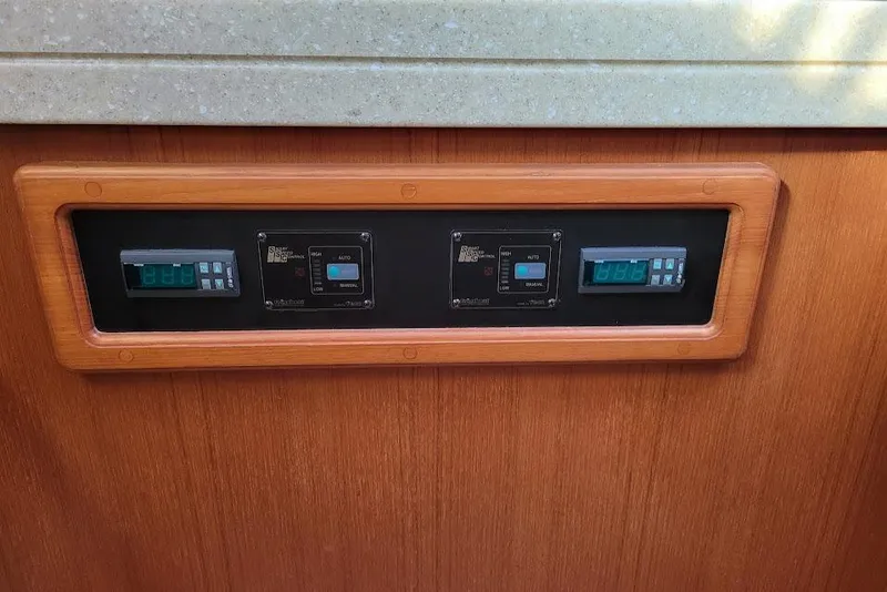 Slide: The Image of Control panel on 2008 Island Packet 370 yacht, featuring digital displays and switches. - 40