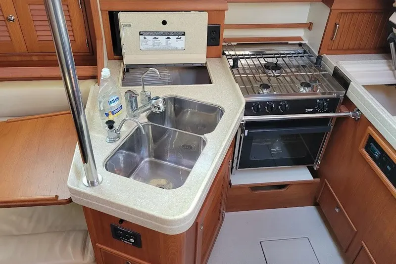 Slide: The Image of 2008 Island Packet 370 yacht kitchen with dual sinks and stove. - 41