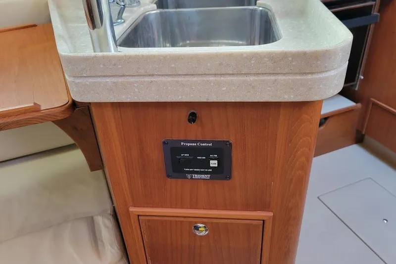 Slide: The Image of 2008 Island Packet 370 yacht kitchen with sink and propane control panel. - 42