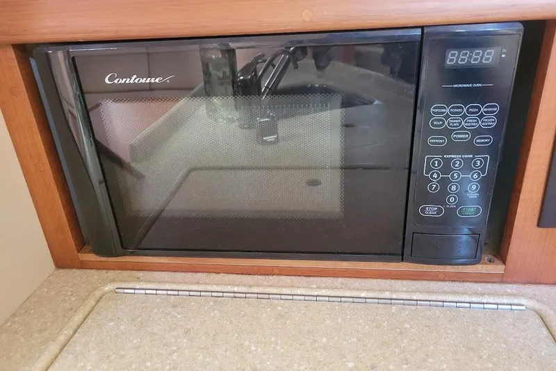 Slide: The Image of Microwave oven in 2008 Island Packet 370 yacht kitchen, featuring Contoure brand and digital controls. - 43