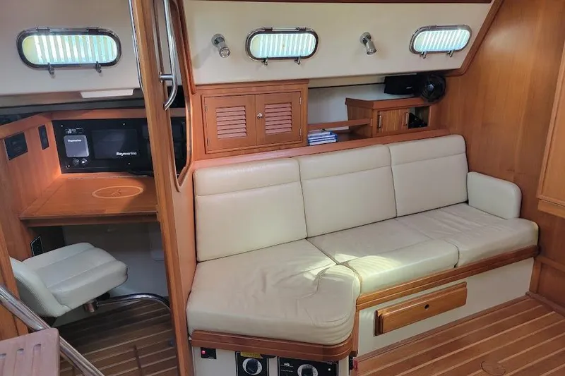 Slide: The Image of Interior of 2008 Island Packet 370 yacht with beige seating and wooden cabinetry. - 48