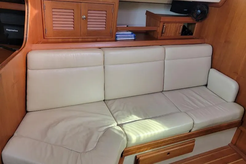 Slide: The Image of 2008 Island Packet 370 interior with cream leather seating and wooden cabinetry. - 49